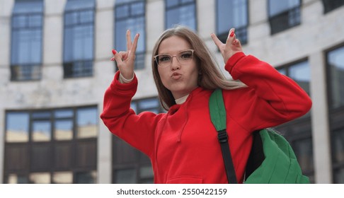 A young woman in a red hoodie shares her frustrations outdoors, capturing student life struggles candidly - Powered by Shutterstock