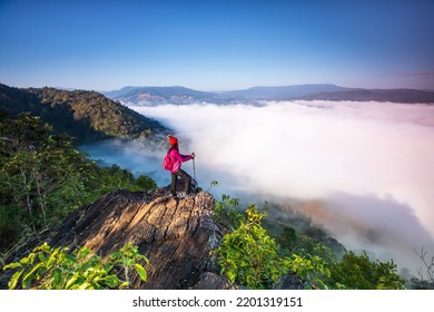 Young woman in red jacket hiking on Pha Muak mountain, border of Thailand and Laos, Loei province, Thailand. - Shutterstock ID 2201319151