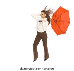 Young woman with red umbrella in hand fighting with strong wind blowing on her. Isolated on white in studio. - Powered by Shutterstock