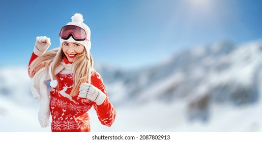 Young Woman In Red Winter Pullover, White Hat And Ski Goggles Looking Happy Smiling, Blurred Snow Country Background, Free Space For Text Right Side