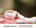 Young woman with reflective vest, places the V16 emergency light beacon on the roof of the damaged vehicle. Help flash, mandatory to replace triangles in Europe. DGT Spain.