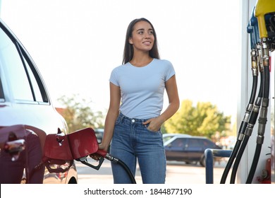 Young Woman Refueling Car At Self Service Gas Station