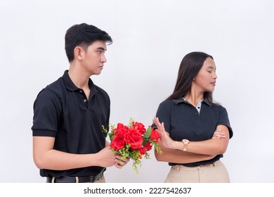 A young woman refuses to accept flowers from an obsessed admirer. Unrequited and one-side love. Isolated on a white background. Dating concept.