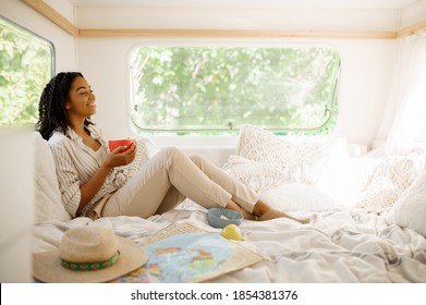 Young woman relax in bed, camping in a trailer - Powered by Shutterstock