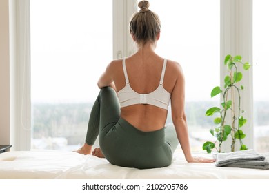 Young woman relaxing after physical therapy or massage session - Shutterstock ID 2102905786