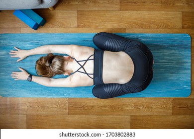 Young Woman Relaxing In Child Yoga Pose At Home. Yoga At Home Top View Concept Background