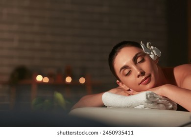 Young woman relaxing in dark spa salon, closeup - Powered by Shutterstock