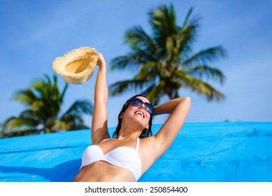 Young Woman Relaxing And Enjoying At Beach During Tropical Caribbean Vacation Travel. Beautiful Girl In White Bikini In Cancun, Mexico.