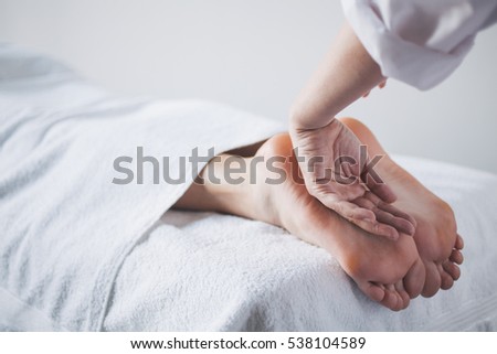 Young woman relaxing with hand massage at beauty spa.