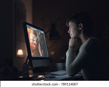 Young Woman Relaxing At Home, She Is Watching Movies And Streaming Online Series