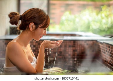 Young Woman Relaxing  In Hot Spring