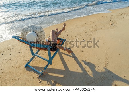 Young woman relaxing on a beautiful exotic beach.