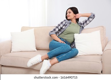 Young Woman Relaxing On Couch At Home
