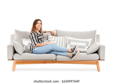 Young Woman Relaxing On Sofa Against White Background