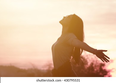 Young woman relaxing in summer sunset sky outdoor. People freedom style. - Shutterstock ID 430795531