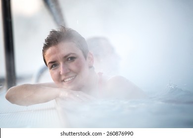 Young Woman Relaxing In Thermal Pool.