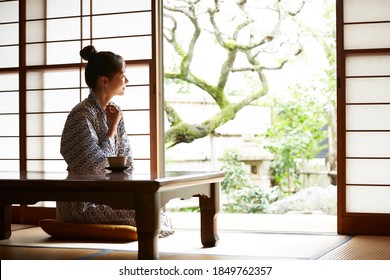 A young woman is relaxing at a traditional Japanese inn