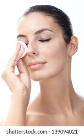 Young Woman Removing Eye Makeup By Cotton Pad Eyes Closed.