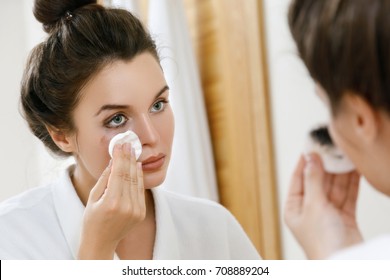 Young Woman Is Removing Makeup With A Cotton Pad