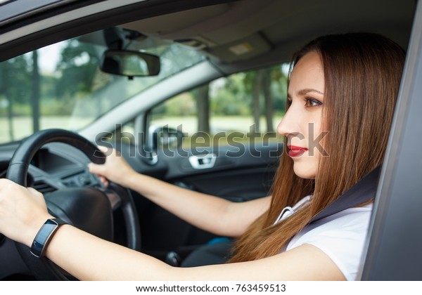Young woman rent a car for travelling. Business woman
sitting in a new car