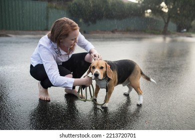 Young Woman With Rescue Dog In The Rain