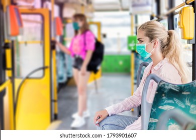 Young Woman With Respiratory Mask Traveling In The Public Transport. Public Transport During The Coronavirus - Concept. Coronavirus, Covid 2019