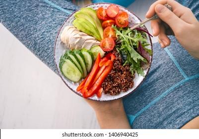 Young Woman Is Resting And Eating A Healthy Food After A Workout. Fitness And Healthy Lifestyle Concept.