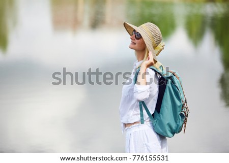 Young woman resting near lake