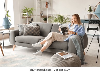 Young woman resting on sofa and reading magazine in white living room - Powered by Shutterstock