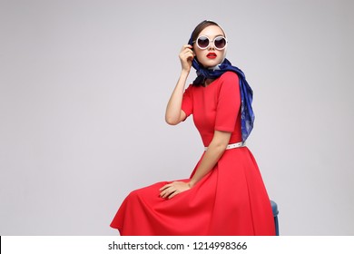 Young Woman In Retro Style. Sunglasses And Silk Scarf. Sixties Style Fashion Retro Woman. 