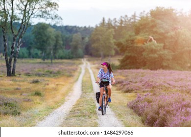 Young Woman Riding Bicycle In The Countryside, Hoge Veluwe, Holland