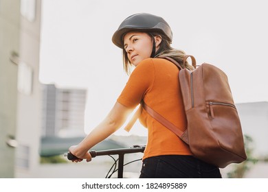 Young woman riding a bicycle through the city - Powered by Shutterstock