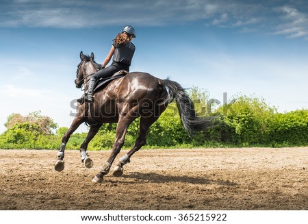 Young woman riding a horse 