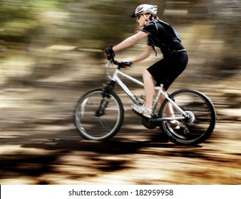 Young Woman Riding Mountain Bike in Wilderness