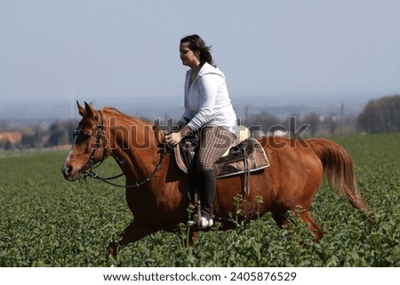 Young woman riding out in field