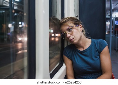 Young Woman Riding A Public Bus At Night