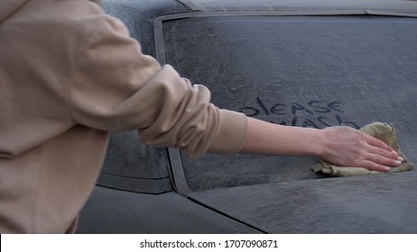 A Young Woman Rinses Off The Inscription On The Machine With A Rag: 