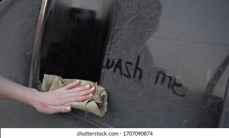 A Young Woman Rinses Off The Inscription On The Machine With A Rag: 