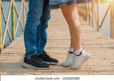 Young woman rises up on tiptoes to kiss lover 