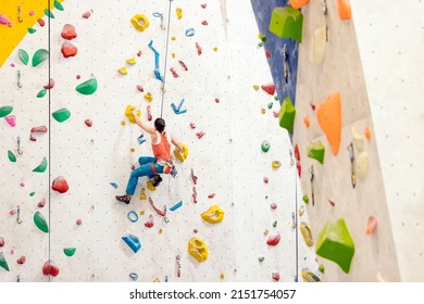 Young Woman rock climbing indoors. - Powered by Shutterstock