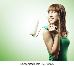 Young woman and roller brush over green background