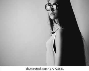 Young Woman In Round Glasses. Black And White. High Contrast