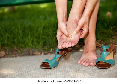 Young Woman Rubbing Her Sore Tired Feet