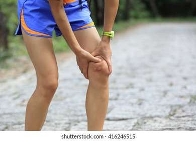 Young Woman Runner Hold Her Injured Knee