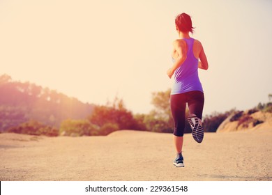 Young Woman Runner Legs Running On Mountain Trail 