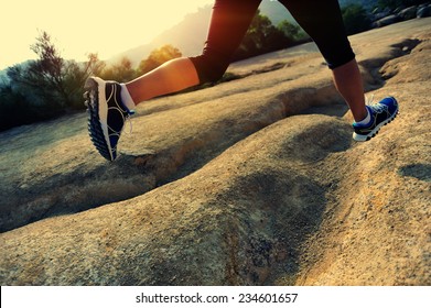 Young Woman Runner Legs Running On Mountain Trail 