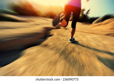 Young Woman Runner Legs Running On Mountain Trail 