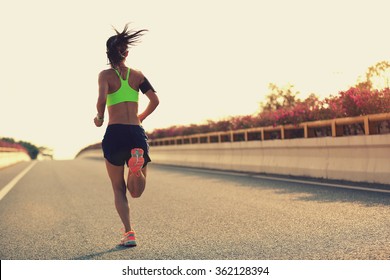 Young Woman Runner Running On City Bridge Road