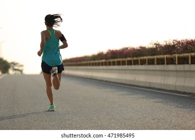 Young Woman Runner Running On City Bridge Road