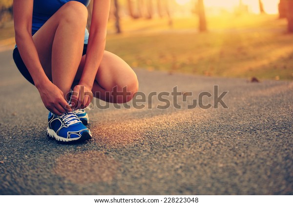 Young Woman Runner Tying Shoelaces Stock Photo Edit Now 228223048